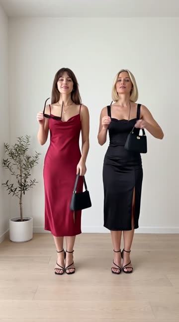 Nora in a wine red satin slip dress and Mia in a black satin midi dress
